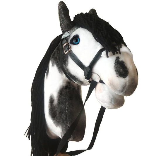 Pinto black and white hobby horse on a stick with black mane, bridle and realistic blue eyes. Handmade hobbyhorse for kids from 4 years.